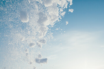 snow splash in the air, blue sky background