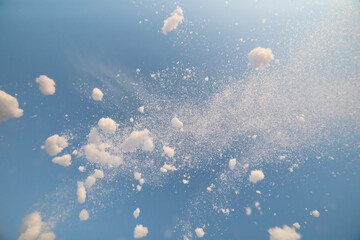 snow splash in the air, blue sky background