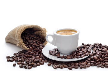Aromatic coffee in a cup, coffee beans isolated on white.