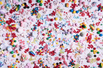 Chocolate coated and jelly beans candy mix. Big explosion of variety colour snack and sugar confetti. Festive dessert of different kinds of soft gummy, lollipop for holiday.