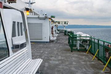 Empty car ferry passenger deck on a calm crossing with a view of the distant horizon