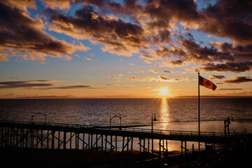 Spectacular sunset at White Rock pier with Canada flag