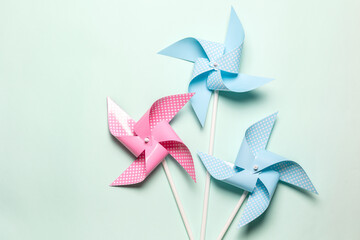 Pink blue paper spinners on light background. Kids toys colorful pinwheels on celebration party...
