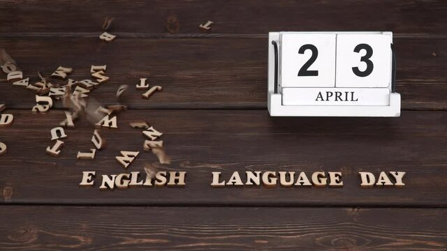 April 23, date on the calendar.  English Language Day. Handmade wood cube with date month and day. Wooden letters on wooden background. english alphabet. 
