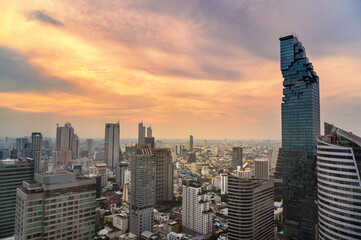 Aerial view of Bangkok city at twilight sunset in Thailand. cityscape of Modern buildings and urban architecture.