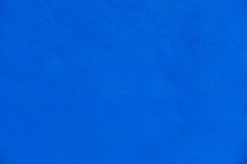 Blank cement plaster wall deep blue color. concrete wall texture for background