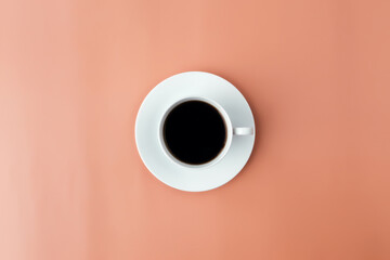 White plate, cup of coffee on beige background