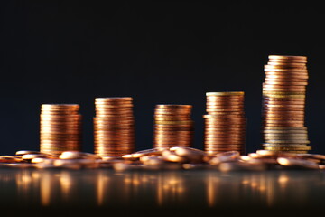 Stacks of gold money coin on black background and concept saving money