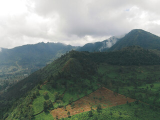 Aerial view of mountain valley with green scenery in Sindoro vulcano