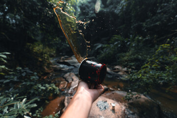 Coffee in a black cup camping in the forest