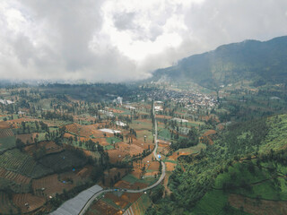 Obraz premium Aerial view of mountain valley with green scenery in Sindoro vulcano