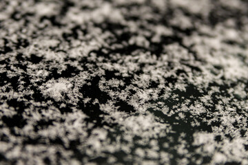 snowflakes on a car windshield, selective focus