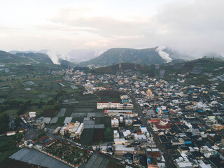 Obraz premium Aerial view of Dieng village at Wonosobo with mountain around it
