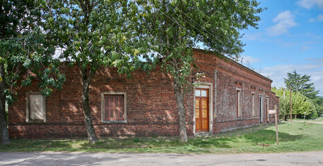 Fototapeta na wymiar Corner with old country house with brick front door and window