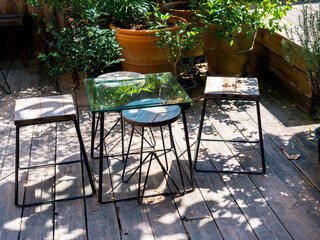 Empty glass table with wooden chairs.