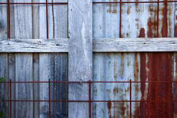 timber paling fence and rusty wire trellis
