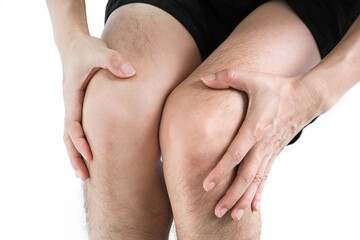 Knee pain .man stand hand caught at the knee.  health concepts