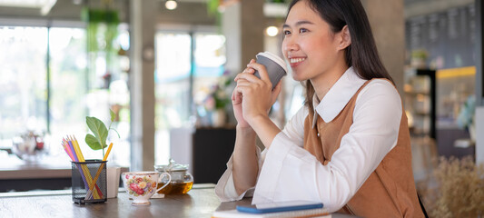 Cropped shot of businesswoman relaxing drinking coffee at a coffee shop.