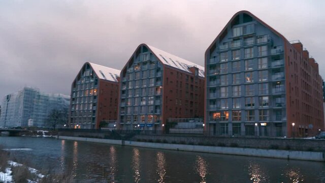 buildings with snowed roofs in a row near the motlawa river at Gdansk Poland
