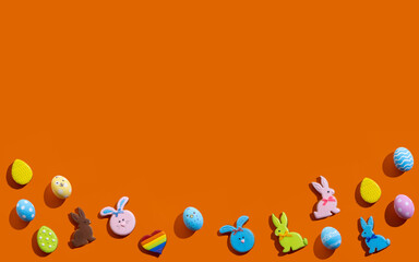 Happy Easter. Holiday banner. Festive design. Greeting card. Bright gingerbread bunny color egg rainbow heart creative pattern isolated on orange copy space background.