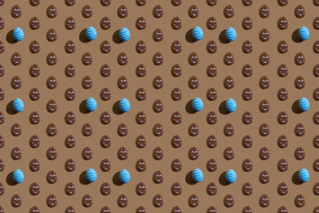 Happy Easter. Seamless background. Holiday ornament. Blue painted stripped egg brown chocolate cookie with smiley face pattern symmetrical composition isolated on beige abstract poster.