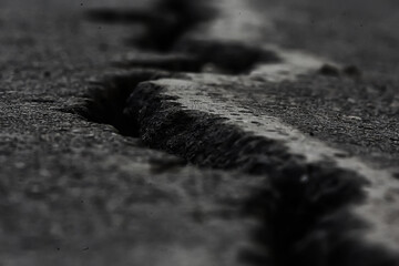 asphalt in cracks texture / abstract background cracks on asphalt road