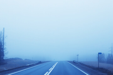 Fototapeta premium abstract winter road fog snow, landscape view in november transport
