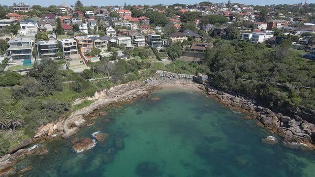 Gordons Bay Beach With Oceanfront Buildings And Hotels At Summertime - Coogee, NSW, Australia. - aerial pullback