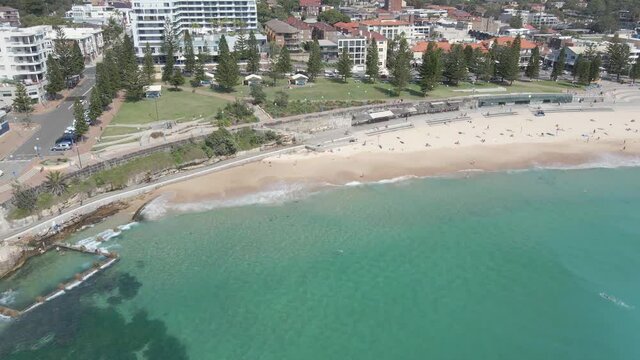 Waves Crashing At Ross Jones Rockpool Near Coogee Beach With Tourists - Goldstein Reserve Park In Coogee, NSW, Australia. - aerial