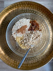 Bananas cookie components in plate before cooking. Including traditional bright tray in the scene. Only day light.