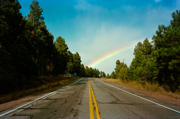 The double yellow lines of a lonely Highway in New Mexico seemingly leading to the base of a...