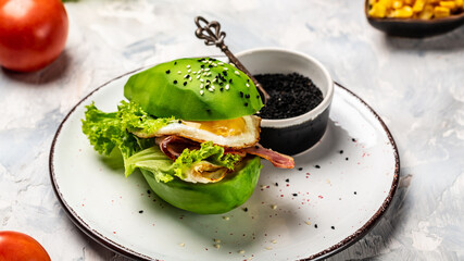 Ketogenic diet breakfast. avocado burger with fried eggs, bacon and fresh salad. Long banner format Copy space for text