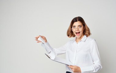 Business woman with documents indoors on a light background and glasses on her face Copy Space