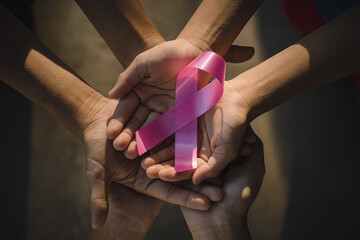 Family hand holding pink ribbon. concept healthcare and medicine, cancer concept