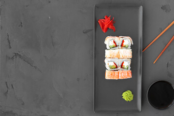 Sushi roll with shrimp on gray background top view