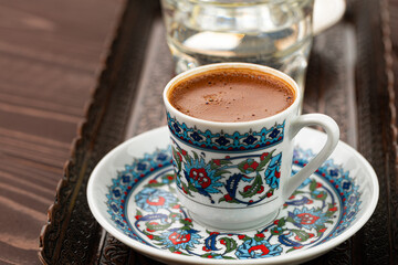 Cup of coffee in oriental style on metal tray