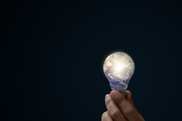 Ecological energy and idea concepts. Light bulb in hand, Hand holding light blue earth bulb....