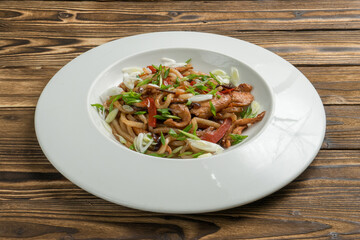 Chinese noodles with chicken fried bell pepper and onion in teriyaki sauce.