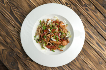 Chinese noodles with chicken fried bell pepper and onion in teriyaki sauce.