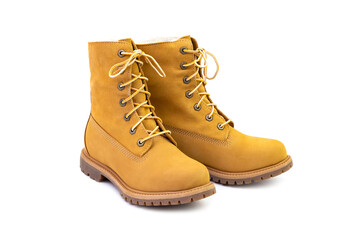 Pair of short yellow leather boots isolated on white background. Fashion and shopping concept