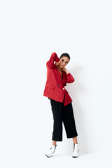 Fototapeta na wymiar woman in red jacket holding hands behind head posing