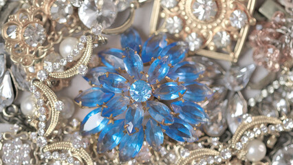 Jewelry. Background from many beautiful female fashion jewel with precious shiny stones, pearls and diamonds for women. Wealth and luxury concept, closeup, macro