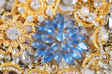 Jewelry. Background from many beautiful female fashion jewel with precious shiny stones, pearls and diamonds for women. Wealth and luxury concept, closeup, macro