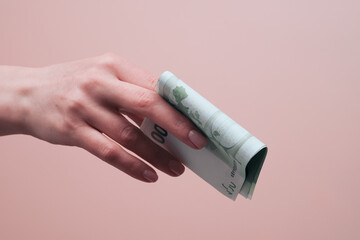 Female hand holding euro banknotes. Allowance and financial aid concept