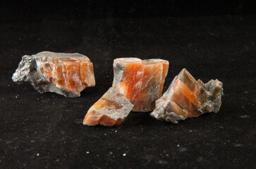 Closeup of fire agate minerals on dark background