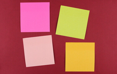Multicolored paper stickers for writing on a red background