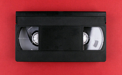 Obraz premium Videotape on a red background. Video cassette