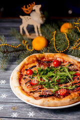 Christmas pizza on the wood board. Holiday celebration pizza. Copy space banner.