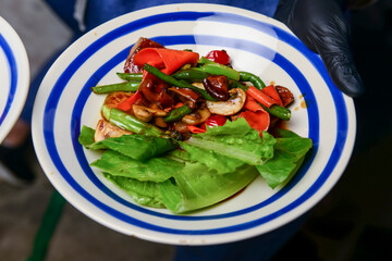 Grilled vegetables with rosemary and thyme on the white ceramic plate. Eating out concept.