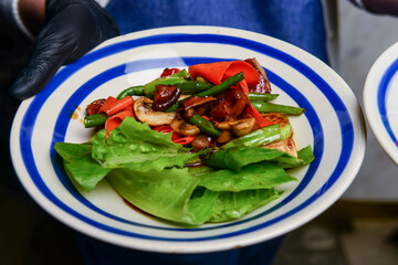Grilled vegetables with rosemary and thyme on the white ceramic plate. Eating out concept.